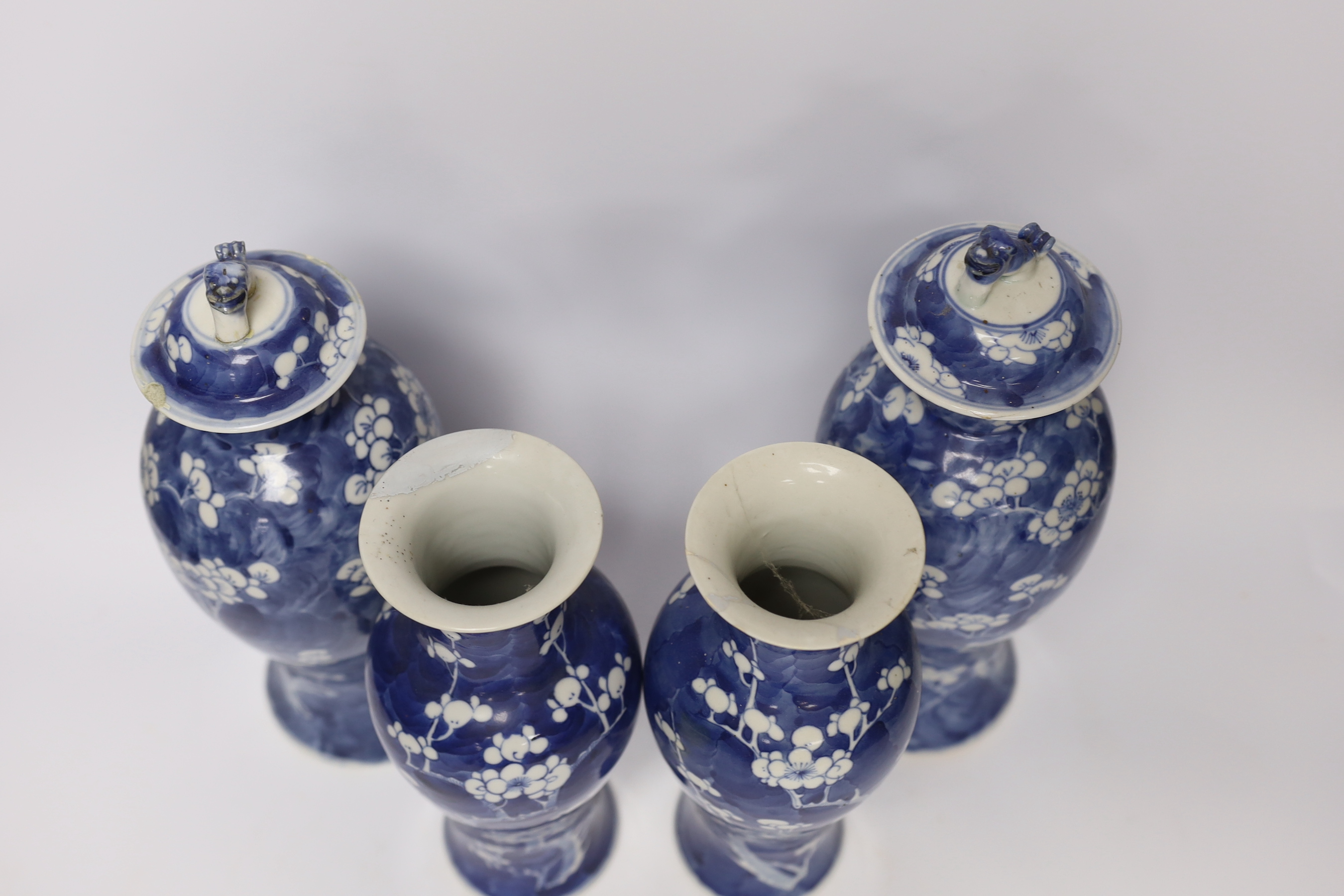 Two pairs of late 19th/early 20th century Chinese blue and white prunus vases, one pair with covers, tallest 30cm